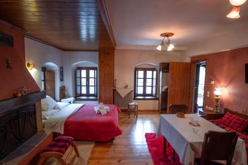 a bedroom with a bed and a couch and a table at Casa Calda in Sirako