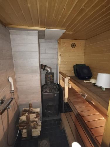 an inside view of a stove in a cabin at Ollilan Lomamajat in Kuusamo