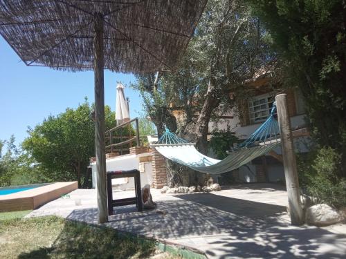 a hammock in front of a house at Finca los Prados in La Iruela