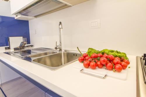 a bunch of vegetables sitting on a counter next to a sink at Primopiano Luxury Accommodations in Vieste