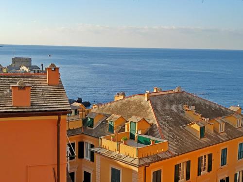 a view of roofs of buildings and the ocean at A due passi dal cielo e dal mare - Balcony with Sea View in Camogli