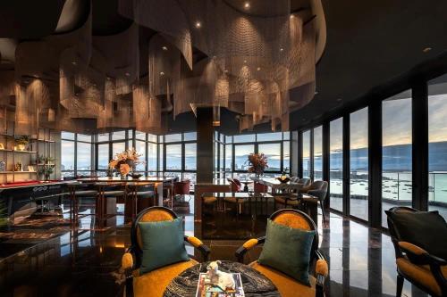 a dining room with a view of the ocean at The Edge central pattaya in Pattaya