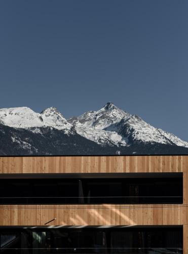 a view of snow covered mountains from a building at Hotel Mühlenerhof in Campo Tures