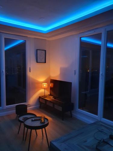 a living room with a television and blue lights at Ultra centre - Certainement la plus belle vue de Pau in Pau
