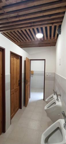 a bathroom with two sinks and two urinals in it at Areál Ontario Kyselka in Kysibl Kyselka