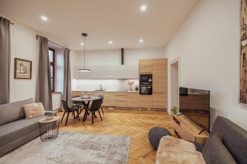 a living room with a couch and a table at Apartmány Marienhof in Znojmo