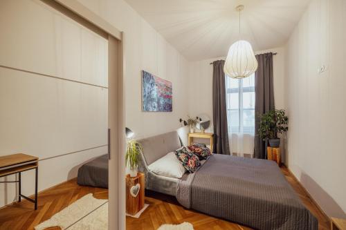 a bedroom with a bed and a desk and a window at Apartmány Marienhof in Znojmo