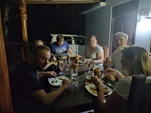a group of people sitting around a table eating at Ceylon Resort in Wilpattu