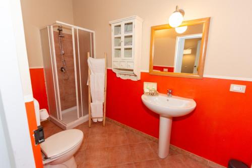 a bathroom with a white toilet and a sink at Tenuta San Giorgio in Serravalle Scrivia
