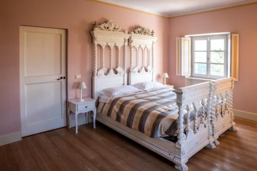 a bedroom with a large bed and a window at Tenuta San Giorgio in Serravalle Scrivia