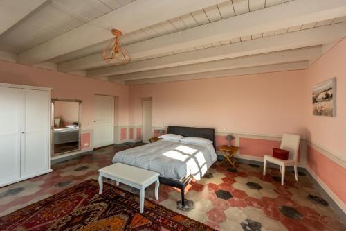 a bedroom with a bed and a table and a chair at Tenuta San Giorgio in Serravalle Scrivia