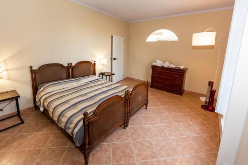 a bedroom with a bed and a dresser at Tenuta San Giorgio in Serravalle Scrivia