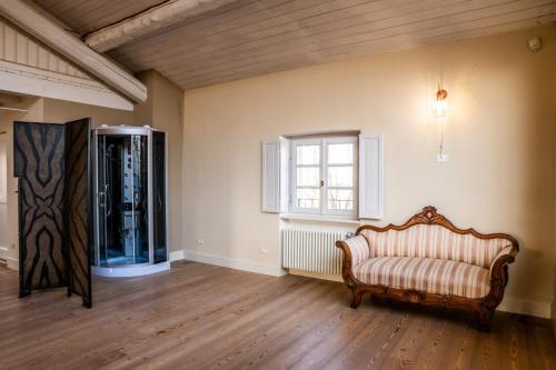 an empty room with a couch and a window at Tenuta San Giorgio in Serravalle Scrivia