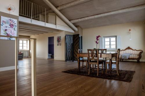a dining room and living room with a table and chairs at Tenuta San Giorgio in Serravalle Scrivia