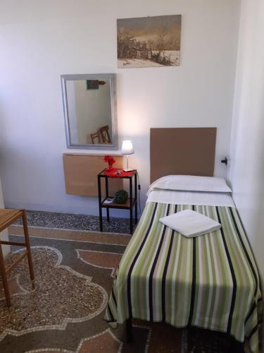 a bedroom with a bed and a table at Albergo Massena in Genoa