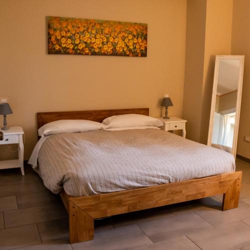 a bedroom with a bed and a painting on the wall at Tenuta San Giorgio in Serravalle Scrivia