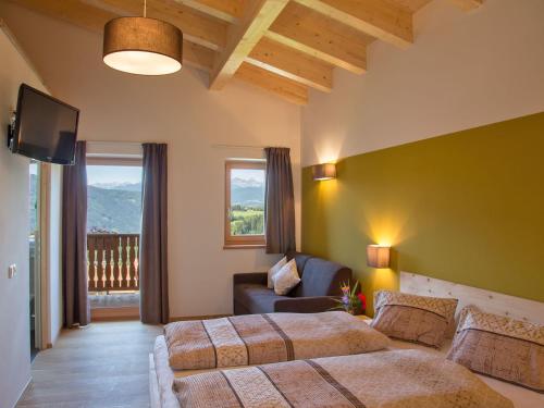 A bed or beds in a room at Naturhotel Edelweiss