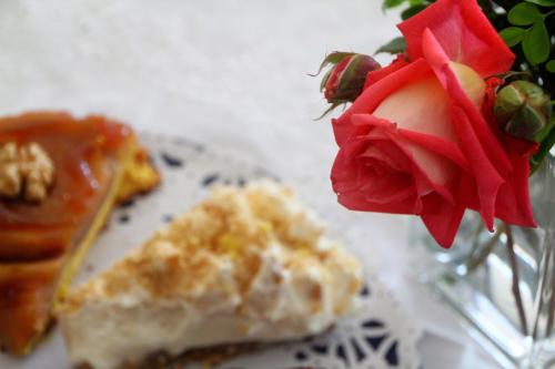 a vase with a rose and a plate with food at Archontiko Elda in Agios Dimitrios