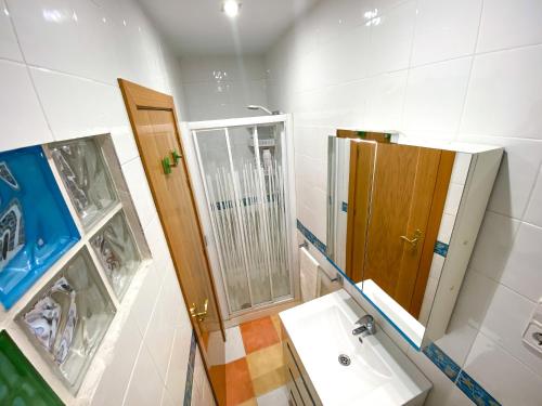 a bathroom with a sink and a mirror at La Casita de Colores de Alicia in Cuenca