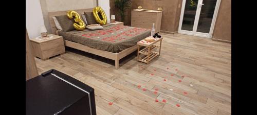 a room with a bed and a television with redbons on the floor at Suite Natura Bed&Beauty Spa in Taranto