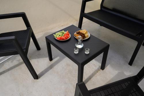 a table with a plate of food and a bowl of fruit at Niki Mountain House in Kamariótis