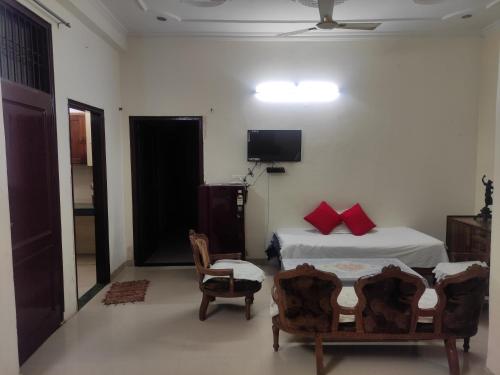 a bedroom with a bed and a tv on the wall at Paradise Villa in Vrindāvan
