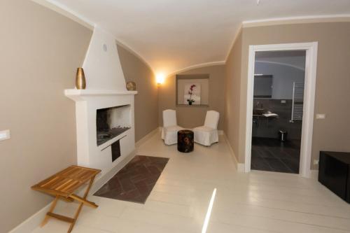 a living room with a fireplace and a staircase at Tenuta San Giorgio in Serravalle Scrivia
