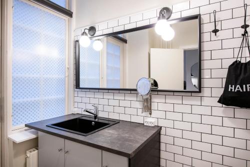 a bathroom with a sink and a mirror at The Citadel Apartments by Daniel&Jacob's in Copenhagen