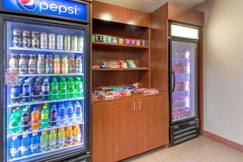 a refrigerator filled with lots of bottles of soda at Comfort Suites Billings in Billings
