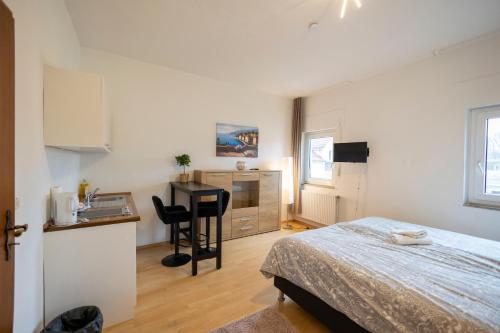 1 dormitorio con 1 cama y cocina con escritorio en BUDGET City Appartement Küche,Bad, Parken im Zentrum von Ravensburg, en Ravensburg