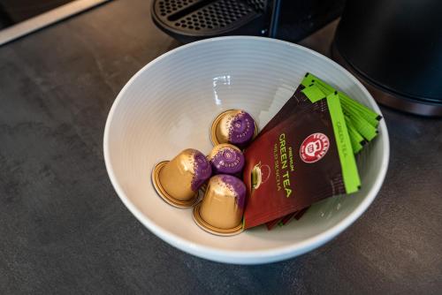 a white bowl filled with chocolate and purple eggs at Gästehaus Wiesengrund & Apart Sporer in Mayrhofen