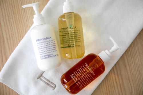 a white towel with two bottles of mouthwash and toothpaste at B:CONTE Asakusa in Tokyo