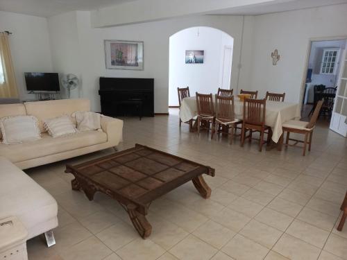 a living room with a couch and a table at Villa L'Oiseau Bleu in Pereybere