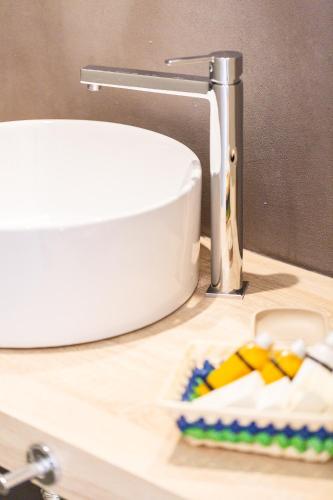 a bathroom sink with a toothbrush on a counter at Ark 68 City Rooms in Rethymno Town