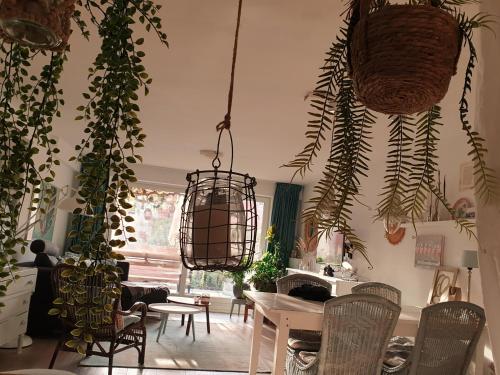 a room with lots of plants and a table and chairs at Beachhouse Engelbert Studios in Zandvoort