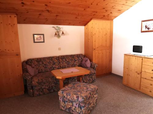 a living room with a couch and a table at Haus Moosplatzl in Leutasch