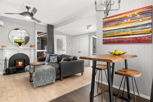 a living room with a couch and a table at Locarno Cottage in Hepburn Springs