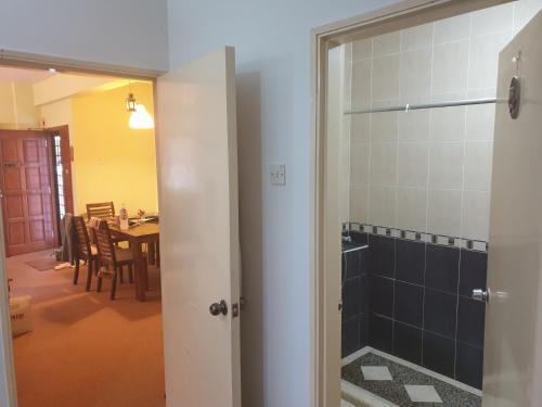 a bathroom with a shower and a dining room at Cool Living at GVR Landed Unit in Genting Highlands