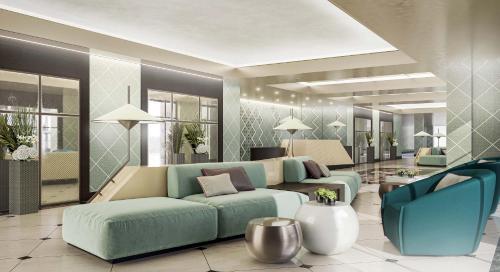a living room with a blue couch and a blue chair at Somerset City Centre Atyrau in Atyraū