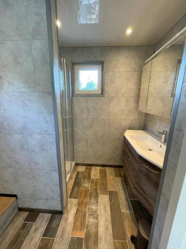 a bathroom with a sink and a shower at Casa 2234 op camping de Schatberg in Sevenum