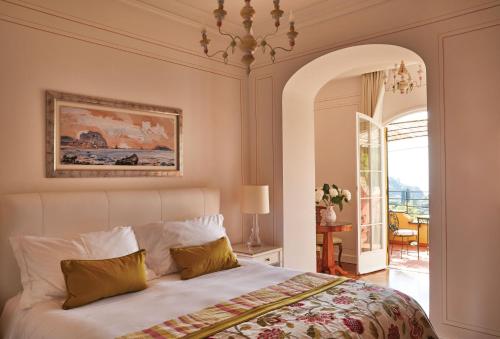 a bedroom with a bed with a painting on the wall at Splendido, A Belmond Hotel, Portofino in Portofino