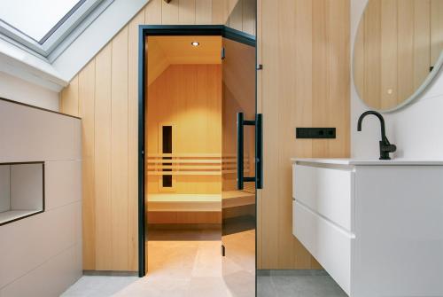 a bathroom with a sink and a mirror at Hello Zeeland - Appartement Weststraat 36 in Domburg