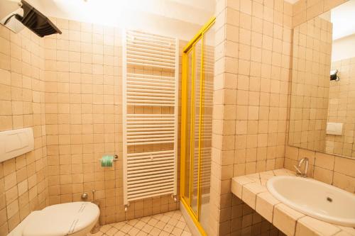 a bathroom with a toilet and a sink at Albergo Al Tempo Perduto in Bagolino