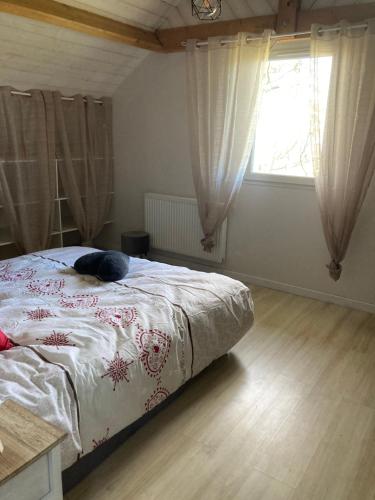 a bedroom with a bed with a cat laying on it at Gîte à la ferme: Coig de Lamothe in Aramits