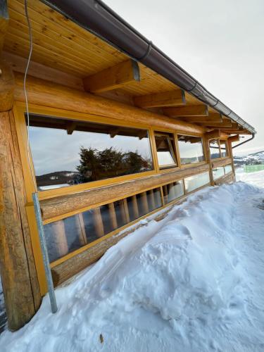 a pile of snow under a house in the snow at Zrubová Chata Sylvester in Oravská Lesná