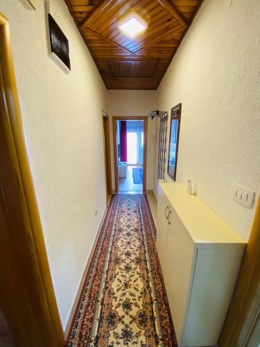 a hallway with a rug on the floor at Apartman Admir in Gladno Polje