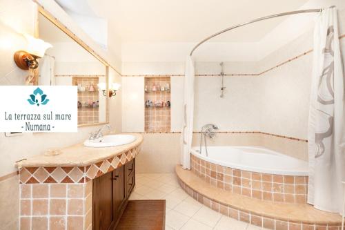 a bathroom with a tub and a sink at LA TERRAZZA SUL MARE - NUMANA - in Numana