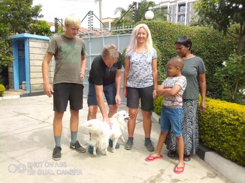 a group of people standing next to a dog at BERNKISH HOMES in Nakuru