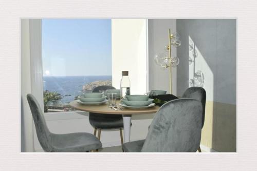 a dining room with a table and chairs and a window at Cocciu d’amuri in Terrasini