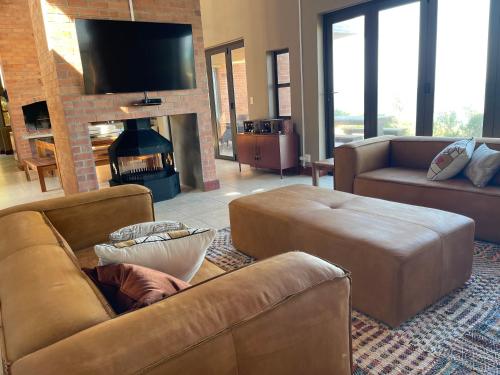 a living room with a couch and a fireplace at 4 Zwaan in Jeffreys Bay